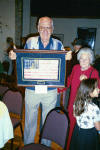 Leonard Hansen with American flag made at prisoner of war camp in wwII