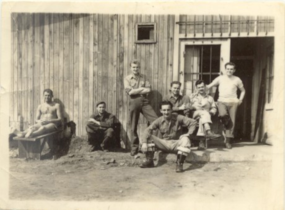 Photo taken at Stalag Luft I. Dominick Tutino is. sitting on step in front....